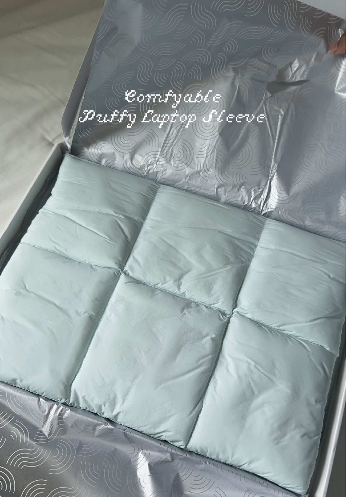TikTok post by @angelinerichard for Comfyable. Caption reads: Puffy Laptop Sleeve from @Comfyable Direct....