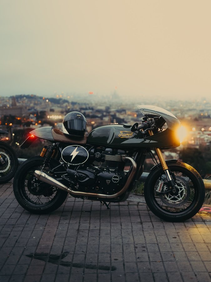 Instagram post by @puko.moto for Peak Design. Caption reads: Sunrise rides, city views, and two years with the....