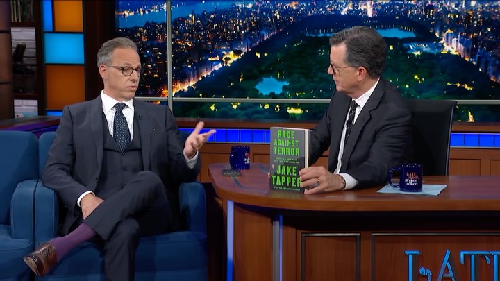 Instagram post by @jaketapper for Atria Books. Caption reads: Jake Tapper and Stephen Colbert had a fantastic....