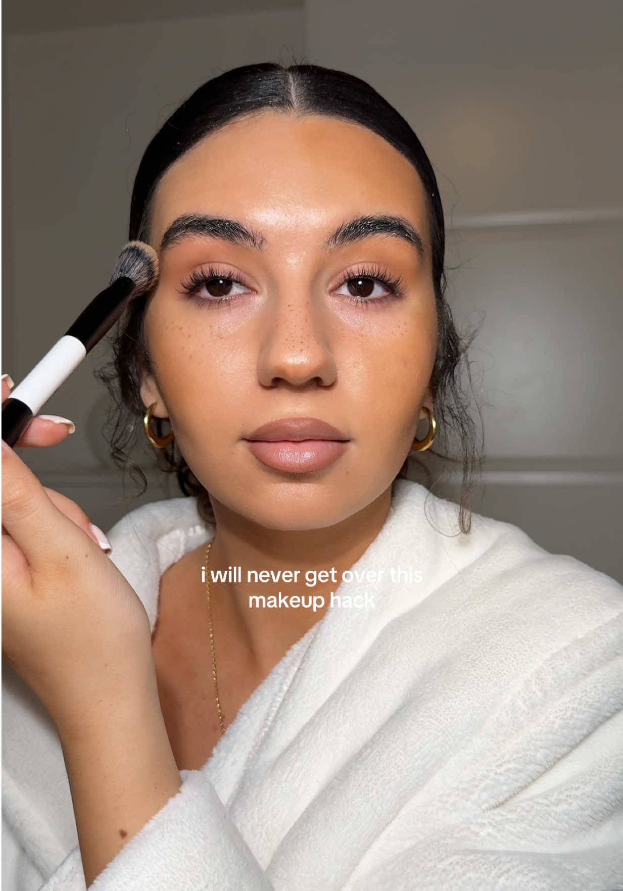 TikTok post by @tias.mua for Saie hello. Caption reads: makes a stiff bronzer so much easier to apply and....