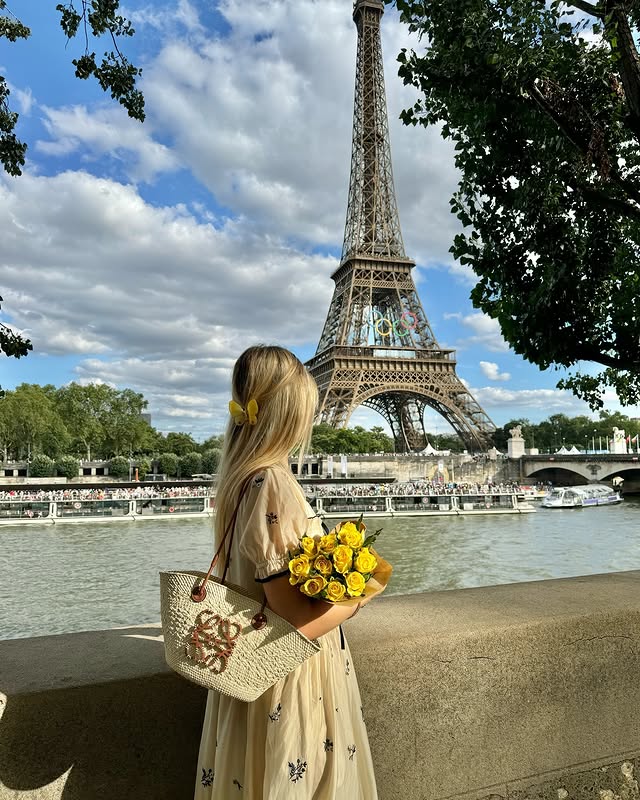 Instagram post by @juliamotoryha for Kuoser. Caption reads: summer time in Paris 🤍✨ Dress: @kuose_official_....
