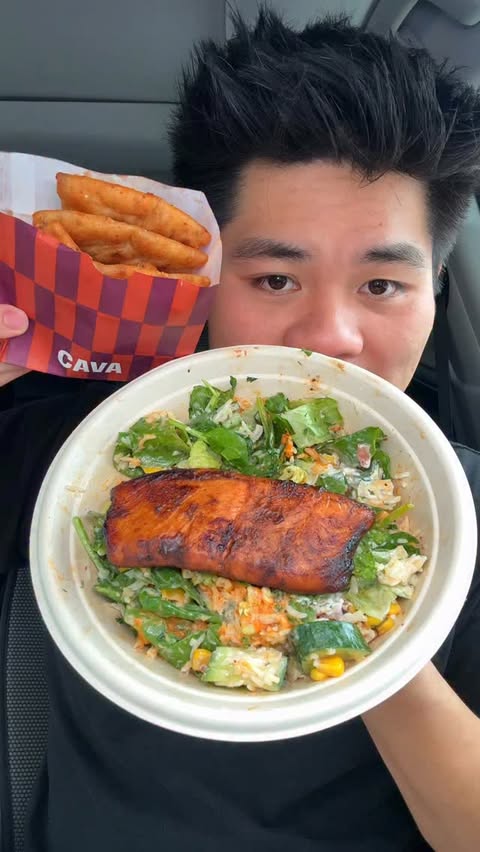 Instagram post by @holycao23 for CAVA. Caption reads: @cava new Salmon and Harissa BBQ pita chips are....