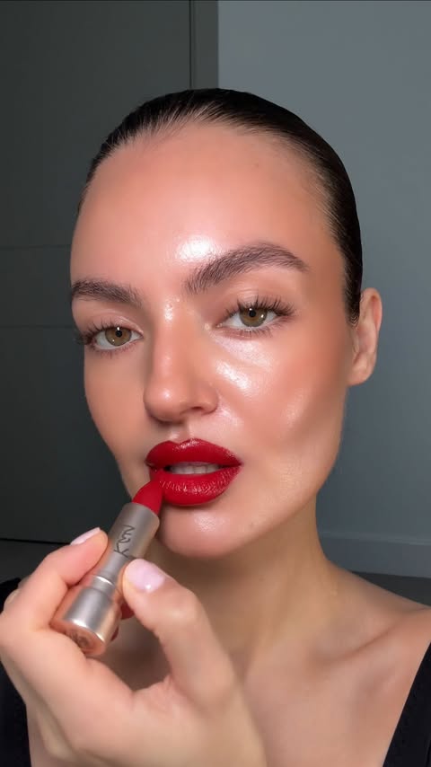 Instagram post by @caressmd for Space NK. Caption reads: the perfect holiday red lip that works for all....