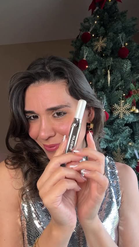 Instagram post by an influencer for SHEGLAM OFFICIAL. Caption reads: ✨ I think I just found my new holiday mascara! 😍....