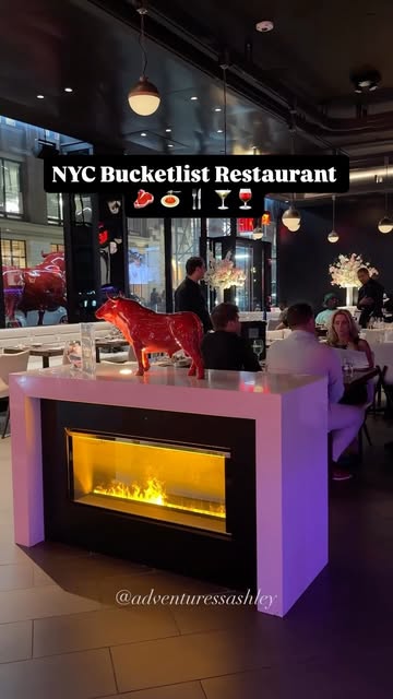 Instagram post by @adventuressashley for STK Steakhouse. Caption reads: NYC Bucketlist Restaurant 𝙎𝙖𝙫𝙚 𝙖𝙣𝙙....