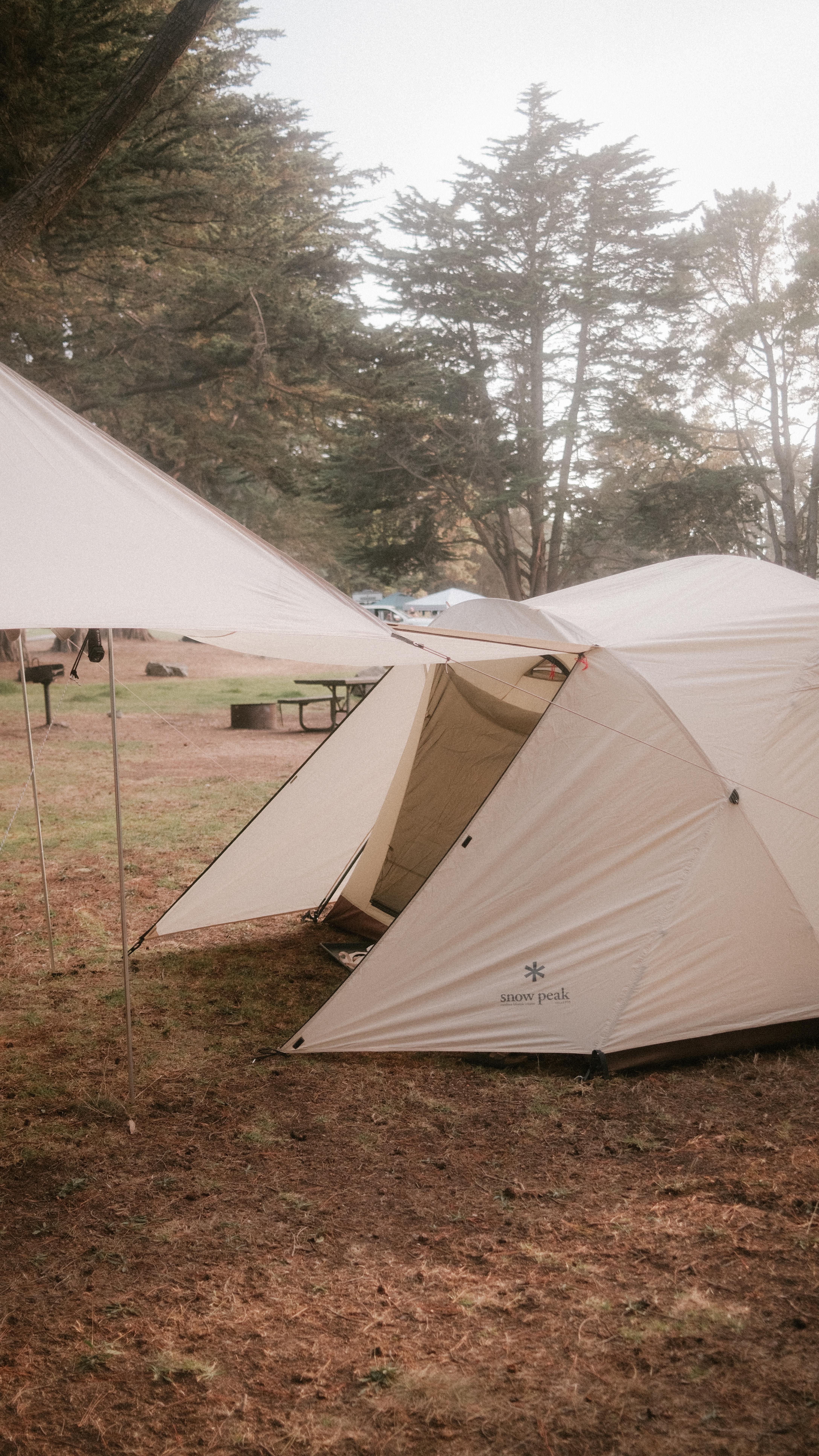 Instagram post by @ericallenluis for Snow Peak. Caption reads: camping in big sur but make it 5120x1080 🎥.