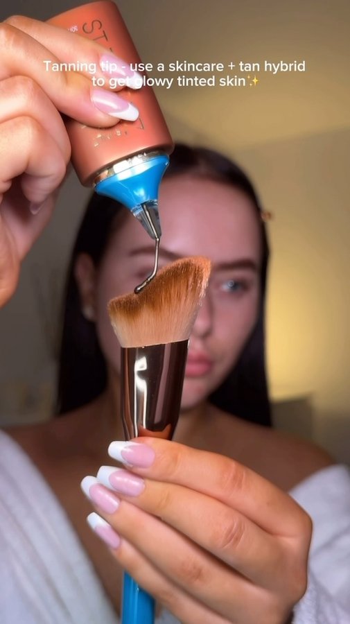 Instagram post by @ellejamesmakeup for St.Tropez. Caption reads: Work smart not hard✨ also the freckles??? Obsessed....