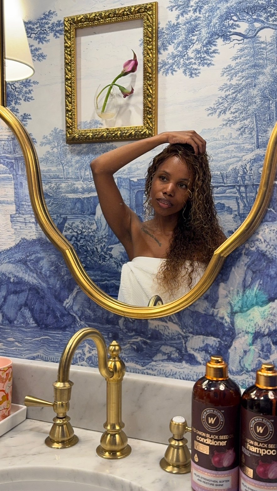 Instagram post by @_simplytasia_ for WOW Skin Science. Caption reads: This NYC heat has had my curls feeling parched,....