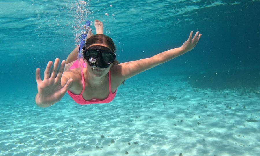 Instagram post by @hatsbyabbey for Norwegian Cruise Line. Caption reads: Abbey learned to swim at age 17 and just 10 years....