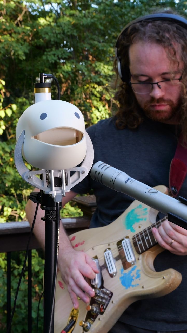 Instagram post by @moshibass for PCBWay. Caption reads: I turned an Otamatone head into a guitar....