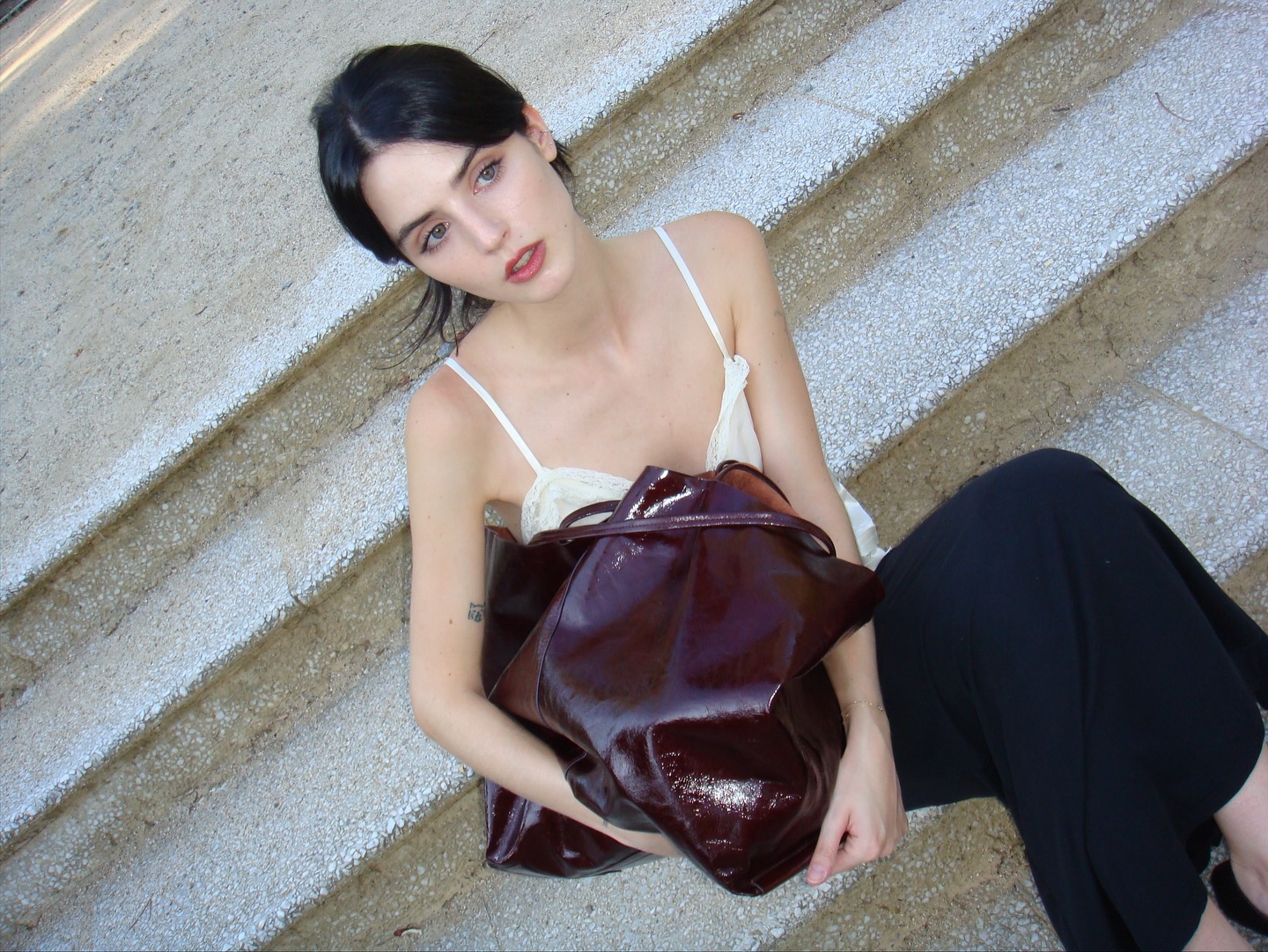 Instagram post by @yuuulieta for BIMBA Y LOLA. Caption reads: Carrying chaos but make it chic @bimbaylola.