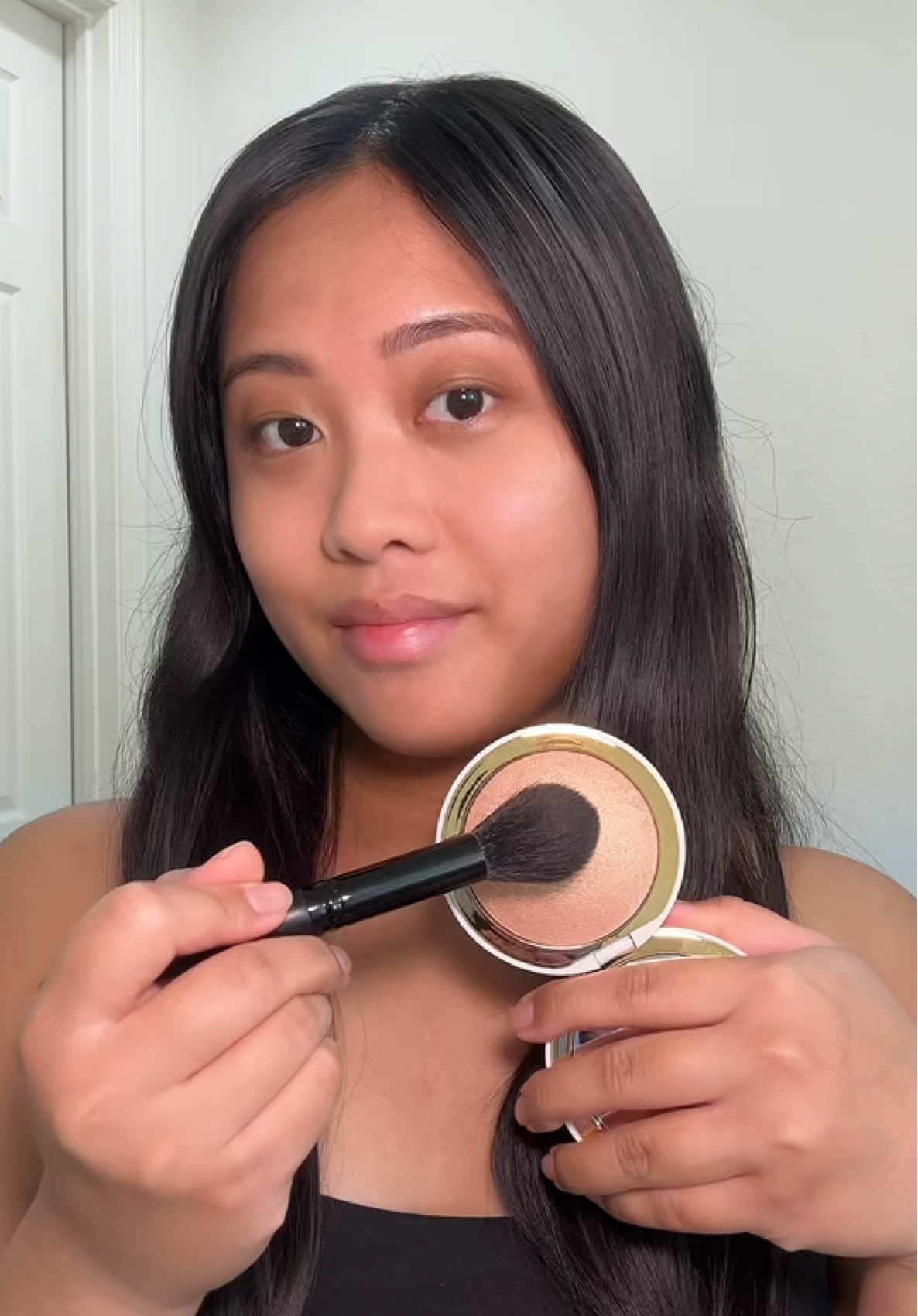 TikTok post by @msmlxo for EM Cosmetics. Caption reads: @EM Cosmetics by Michelle Phan highlighter in the....