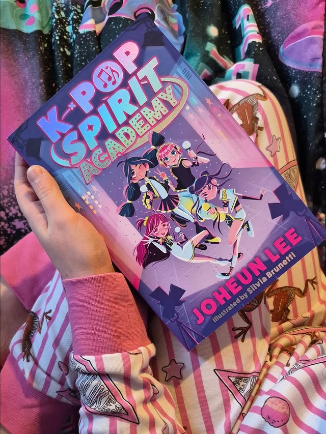 Instagram post by @amy_motheringarainbow for Farshore Books. Caption reads: [...] ❤️ #kidsbooks #kpopbooks @farshorebooks.