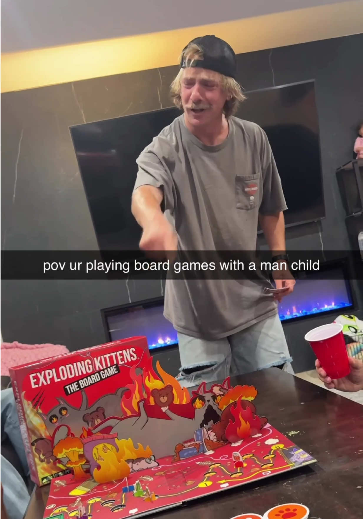 TikTok post by @cherdleys for Exploding Kittens. Caption reads: who invited this dude 😭😤 #EKPartner @Exploding....