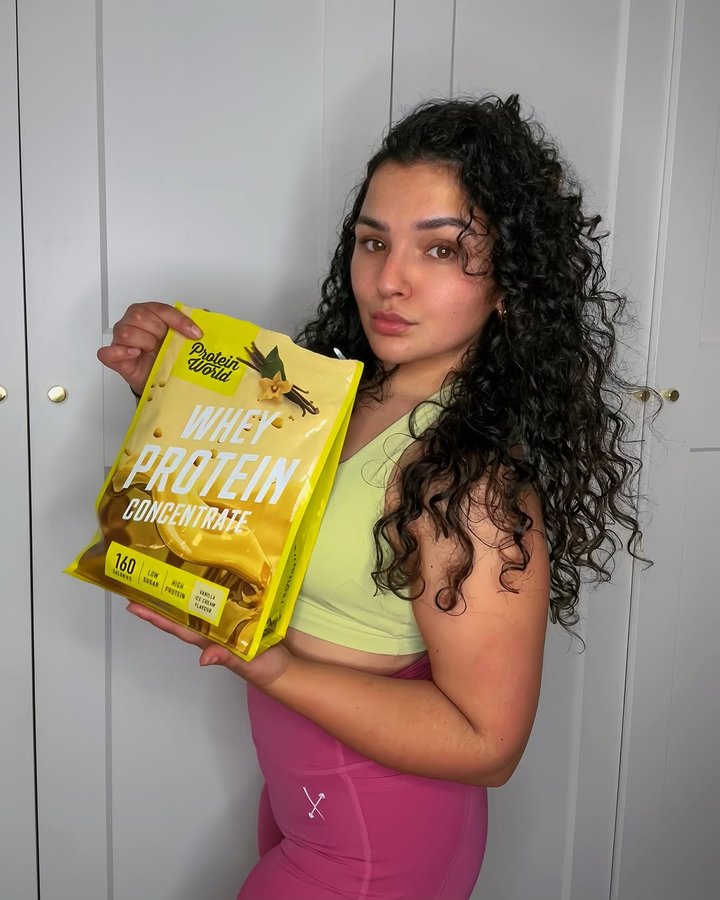 Instagram post by @_tyrajadexo for Protein World. Caption reads: [...] best way to kickstart the day 🍦💛🌟....