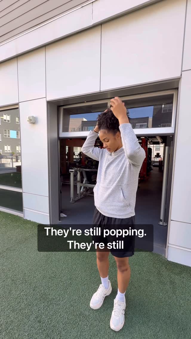 Instagram post by @dominiquealexisdarius for DevaCurl. Caption reads: [...] my curls stay soft and defined with....