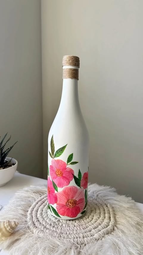 Instagram post by @crafter_happybd for MEEDEN ART. Caption reads: DIY Decopage Bottle Art idea 🌸🌿 Acrylic colour....