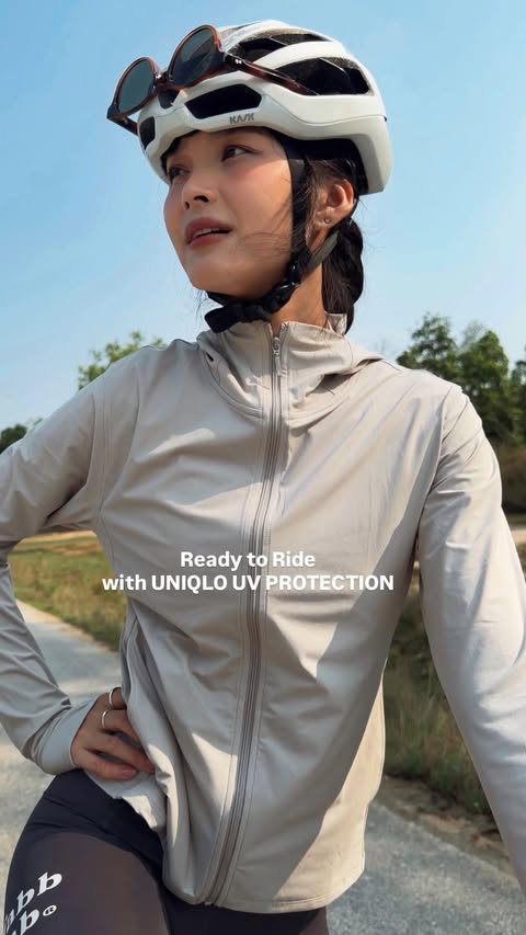 Instagram post by @apisarast_ for UNIQLO Thailand. Caption reads: [...] 🚴‍♀️ with UNIQLO UV PROTECTION....