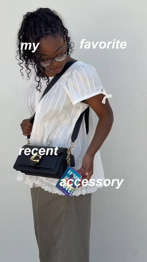 Instagram post by @kimmybookss for Coach. Caption reads: My Coach Book Charm has become a daily [...].