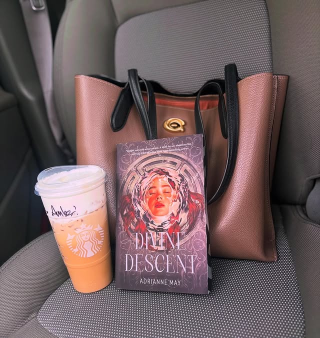 Instagram post by @ambersmagicallibrary for Simon & Schuster. Caption reads: BOOKMAIL: Divine Descent by Adrianne May 🖤✨💌....