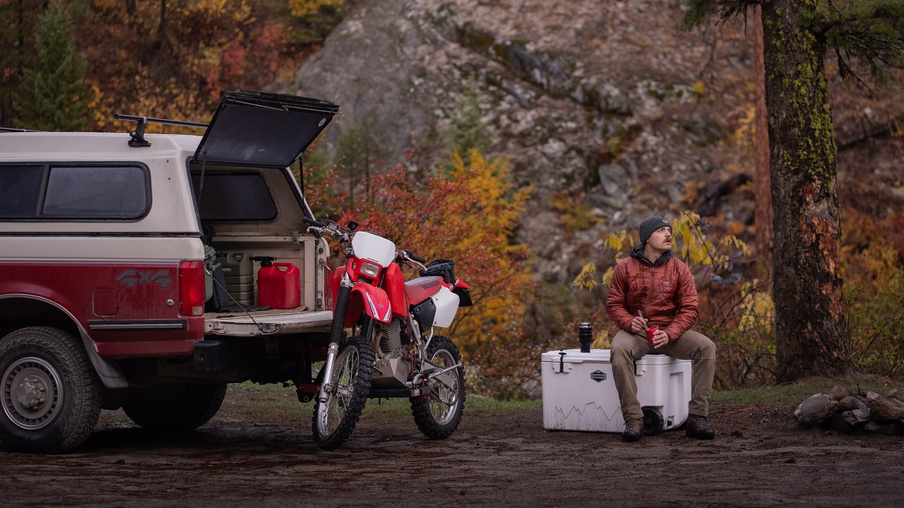 YouTube post by @ChaseChristopher1 for Huckberry. Caption reads: Fall Truck Camping +  Dirt Biking in Snow.