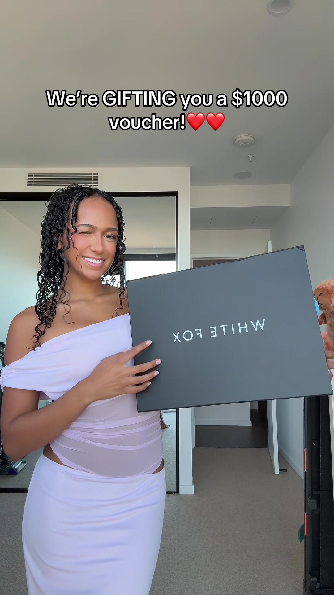 TikTok post by @latishaclarkk for White Fox Boutique. Caption reads: Need a new wardrobe? We are gifting you a $1,000....