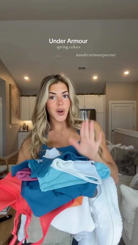 Instagram post by @madisonsvetz for Under Armour. Caption reads: Spring Colors from @underarmour ! 🧡💗❤️🤍 Use....