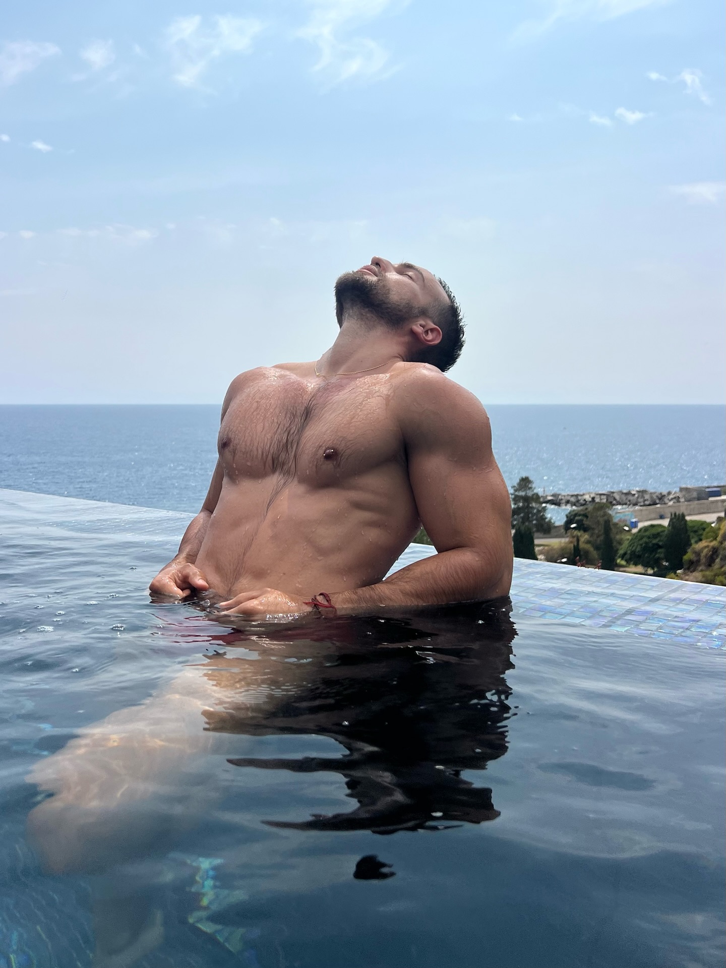 Instagram post by @davidescri for The Gay Passport. Caption reads: Where the ocean meets the edge of calm....
