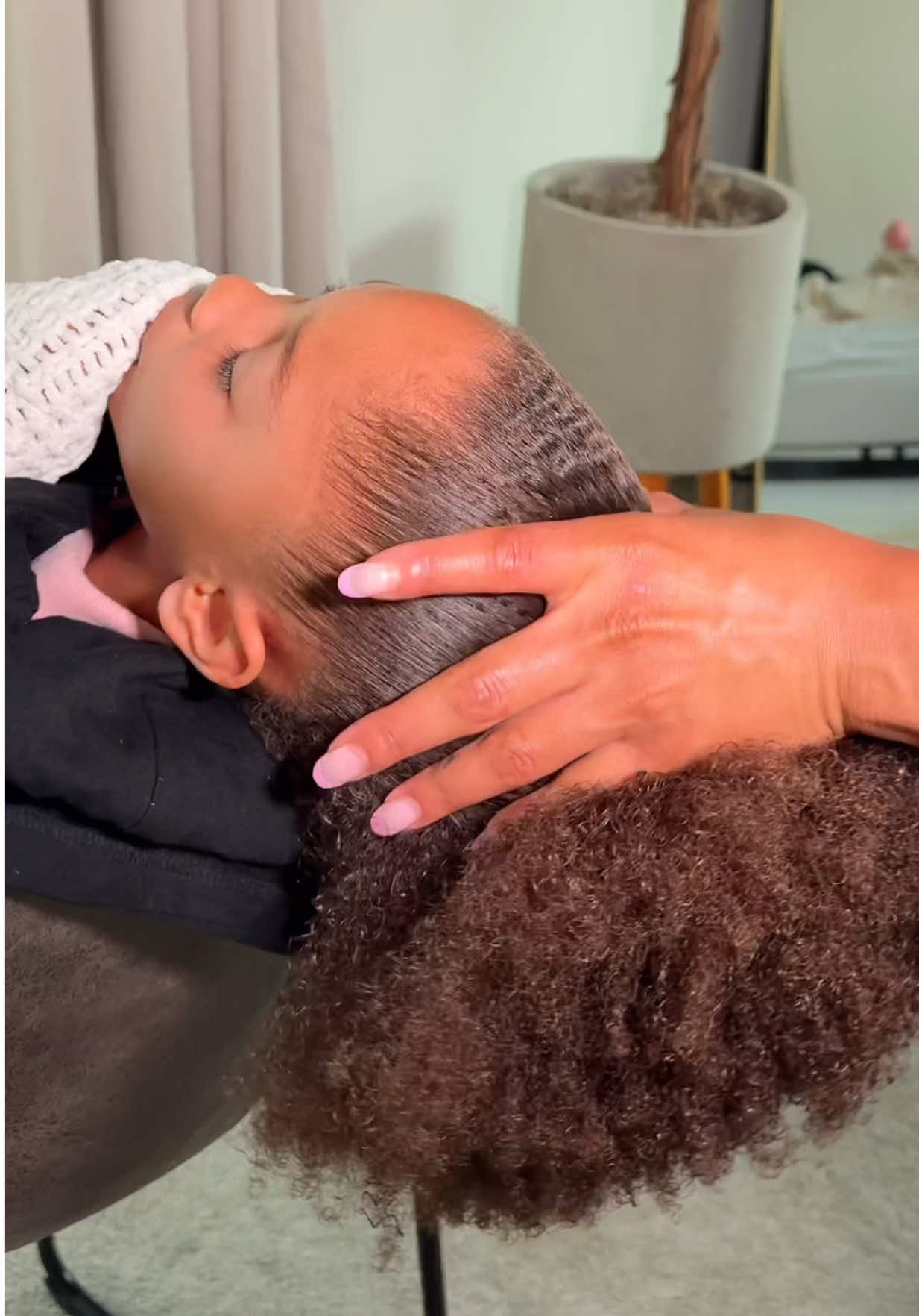 TikTok post by @itsmyrayeraye for FHI Heat. Caption reads: Doing Zoe’s hair while she’s half asleep is....