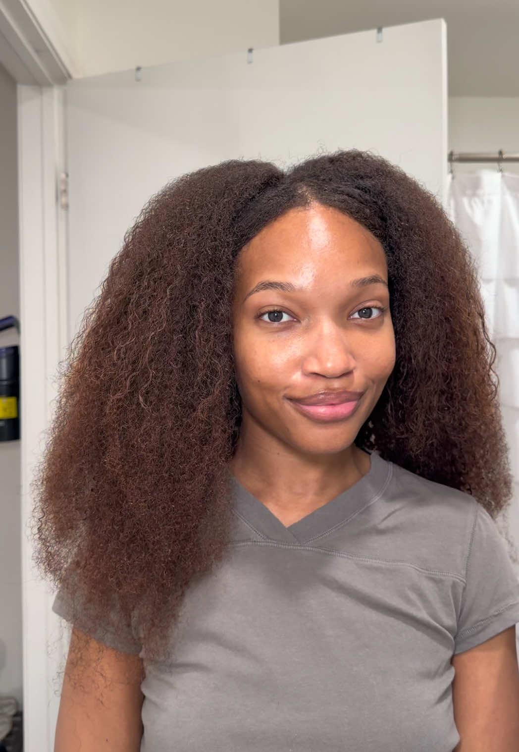 TikTok post by @tiffanytori for OQHAIR. Caption reads: Afro curly v part wig literally giving scalp!....