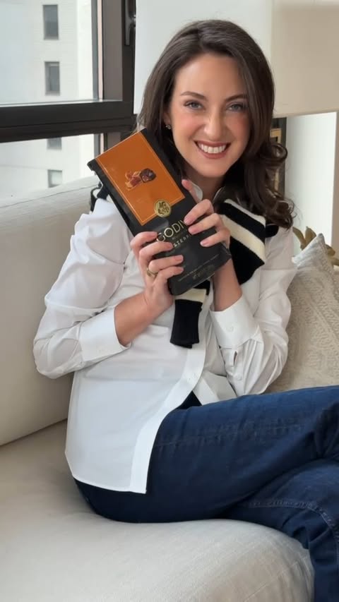 Instagram post by @micaela for GODIVA. Caption reads: Busy day, sweet ending. A piece of @Godiva is my....