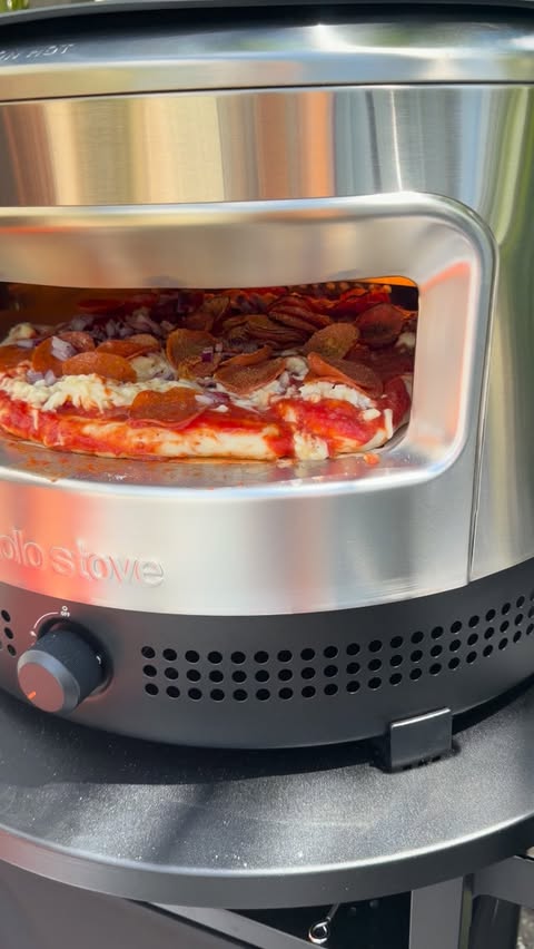 Instagram post by @family.barbell.club for Solo Stove. Caption reads: If you’re making pizza at home, the @solostove Pi....