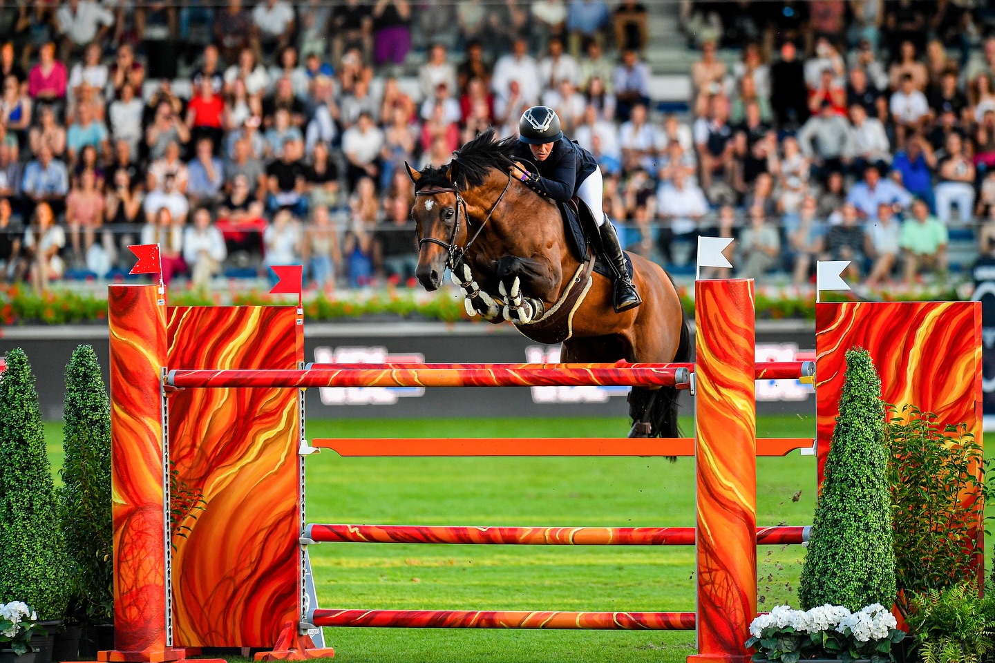 Instagram post by @longinestopsinternationalarena for Longines. Caption reads: Can you guess our color of the day? 🤩🧡 Happy....