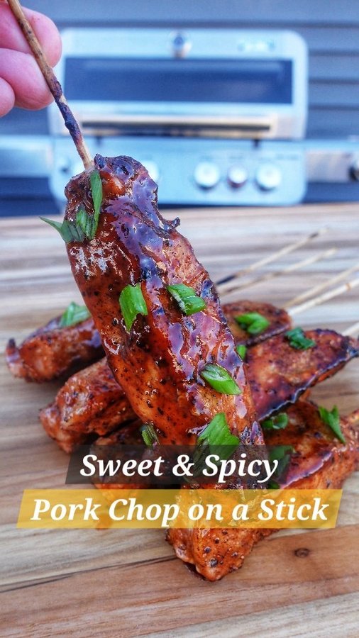 Instagram post by @smoke_stone_cuisine for Monument Grills. Caption reads: Sweet & Spicy Pork Chop on Stick (Recipe Below 👇)....