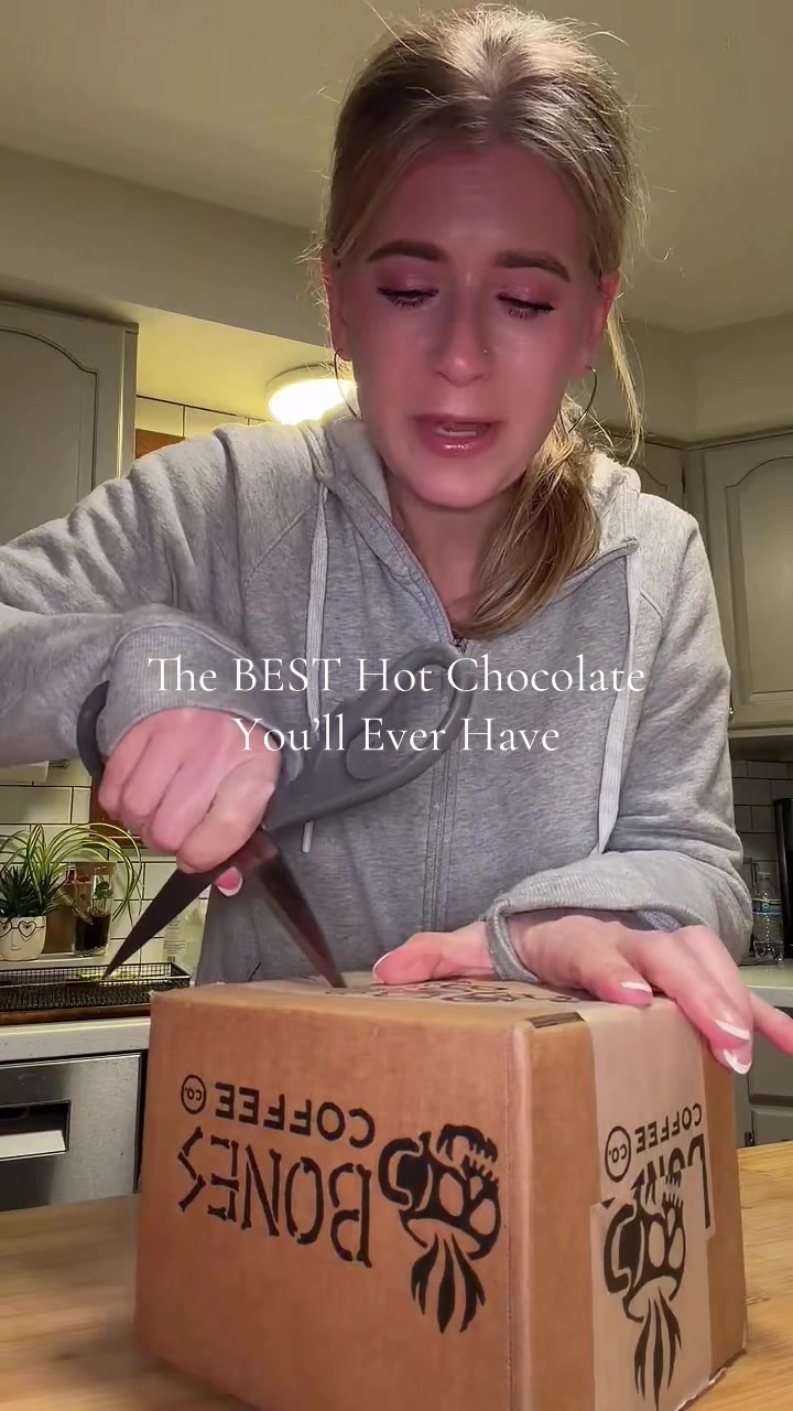 TikTok post by @iamsarahtonin for Bones Coffee Company. Caption reads: This hot chocolate is different! I add it to milk....