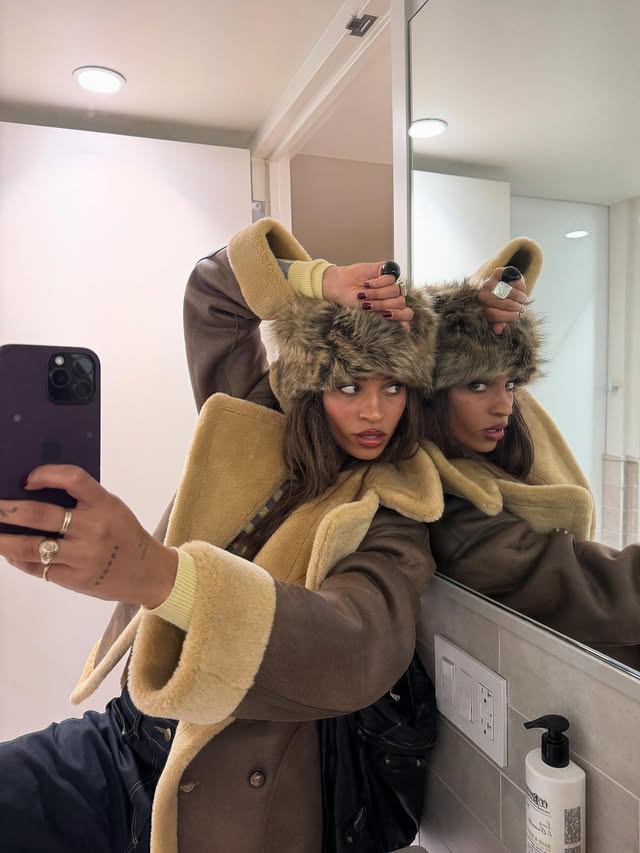 Instagram post by @chelseajordan for Free People. Caption reads: Can you tell I just bought my new favorite hat🤓?.