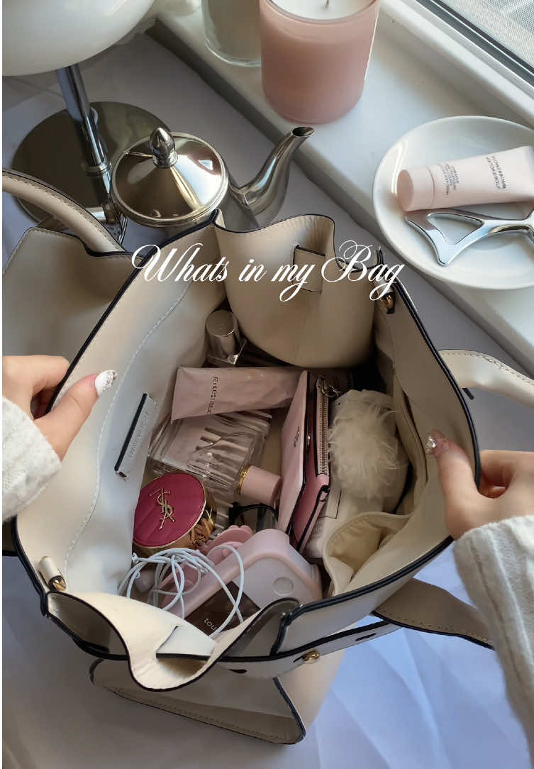 TikTok post by @jaeinpink for Touchland. Caption reads: Whats in my bag ASMR edition~✨🤍 @Burberry....