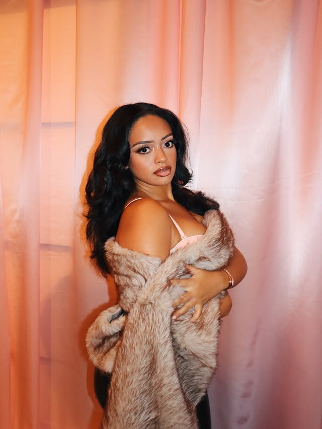 Instagram post by @jasmyndestine for JLUXLABEL. Caption reads: [...] NY girlala of me 🙂‍↕️👸🏽 Fur wrap:....