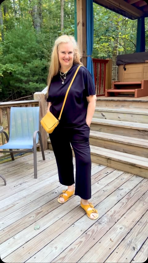 Instagram post by @yogathroughmenopause for Portland Leather Goods. Caption reads: One outfit, so many ways to wear it! 🖤 This black....