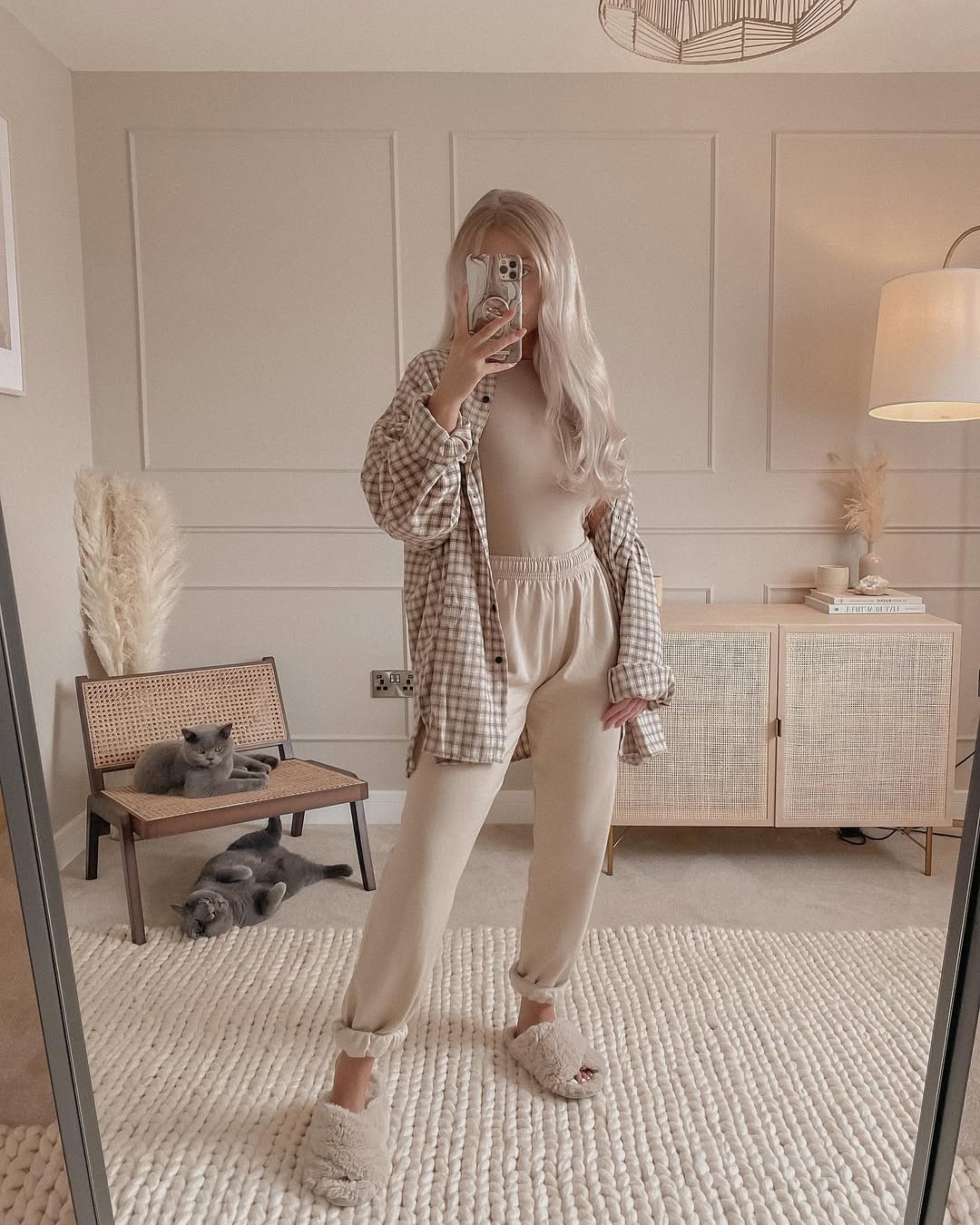 Instagram post by @_gemmalouisemiles for ISAWITFIRST. Caption reads: a neutral checked shirt styled 3 ways, which is....