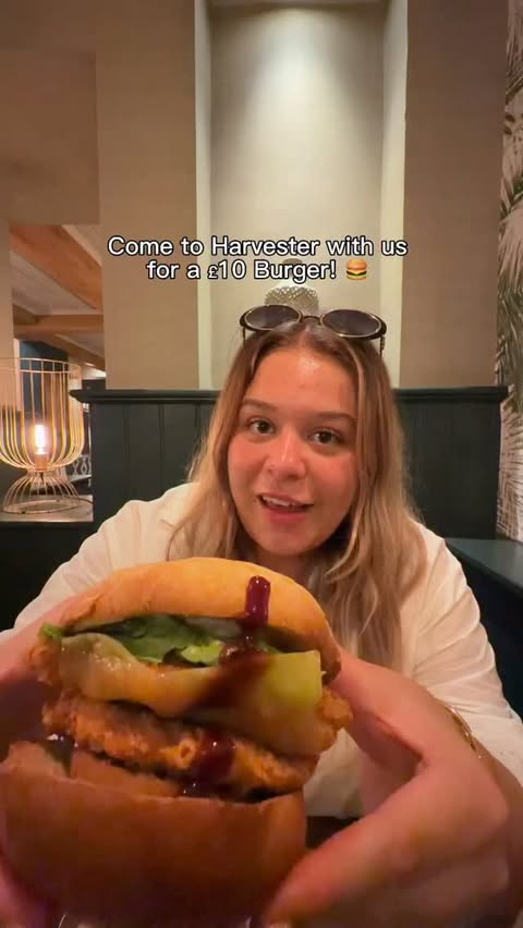 Instagram post by @tanayagreenn for Harvester. Caption reads: AD Come to Harvester with us for a £10 Burger 🍔....