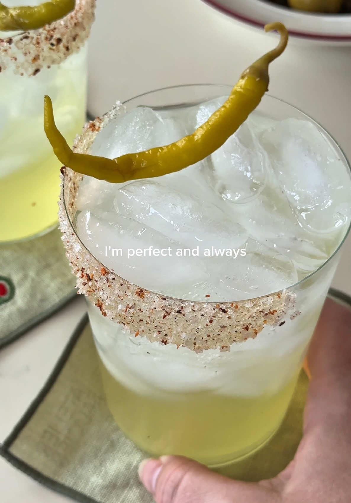 TikTok post by @babytamago for Q Mixers. Caption reads: pepperoncini margs & snacky bits for the perfect....
