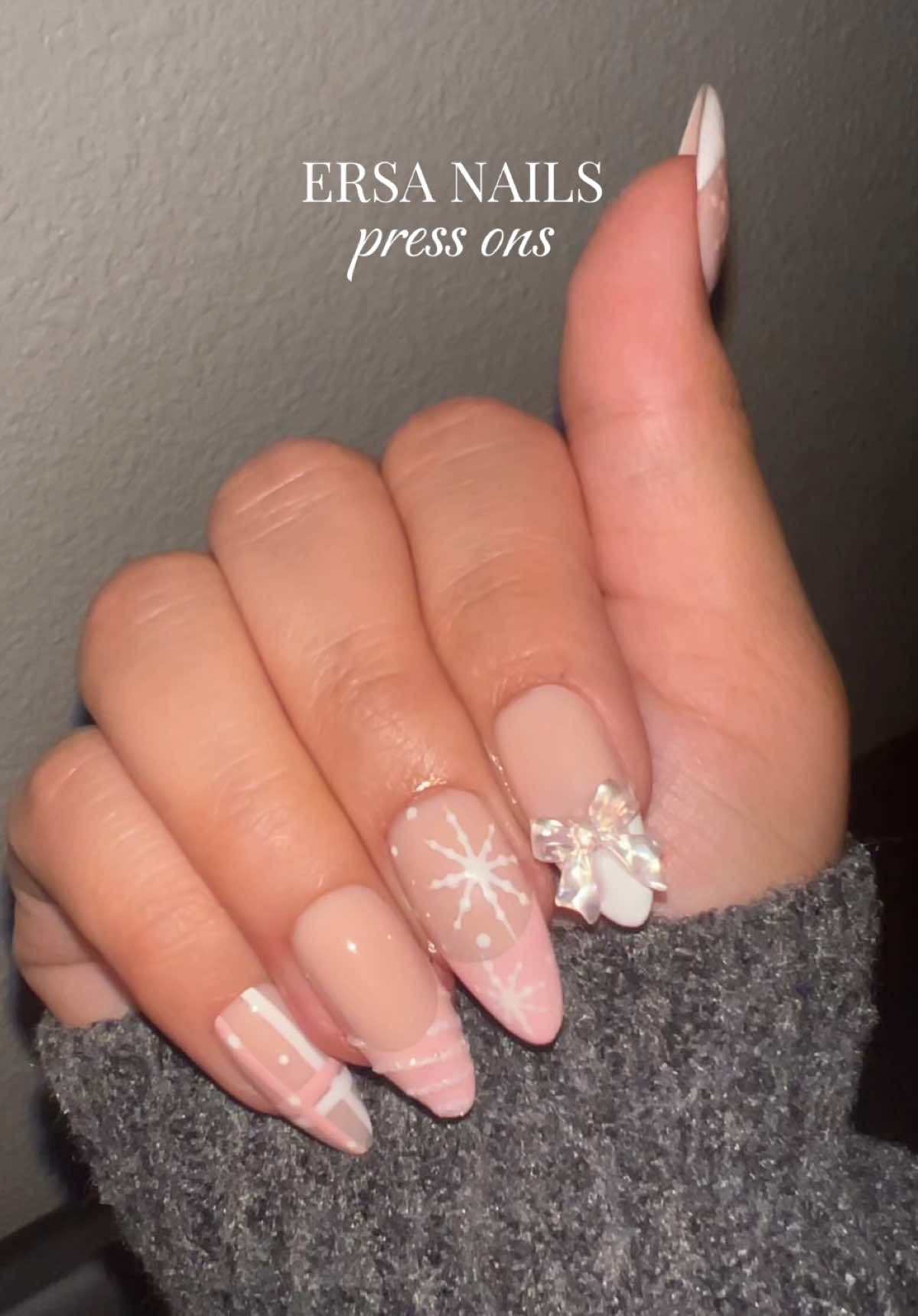 TikTok post by @melimichellel for Ersa Nails. Caption reads: [...] ons for this holiday ❄️🎀🤍💅🏼  @Ersa Nails....
