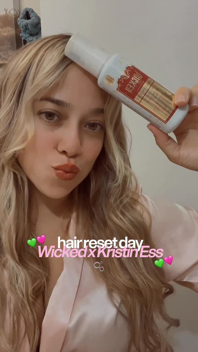 Instagram post by @andrealissette for Kristin Ess Hair. Caption reads: [...] the hair must always slay 💚🩷....