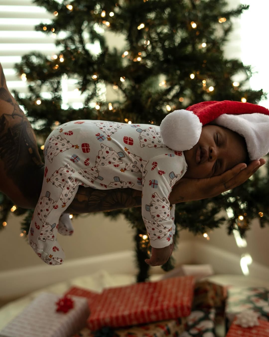 Instagram post by @loveatfirstflight_ for Caden Lane. Caption reads: Just call us ✨Mama & Daddy Claus✨🤶🏾🎅🏾

#ad I....