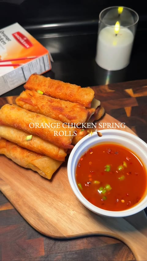 Instagram post by @kitchenlovergurl for InnovAsian Cuisine. Caption reads: Orange Chicken Spring Rolls #innovasianpartner....