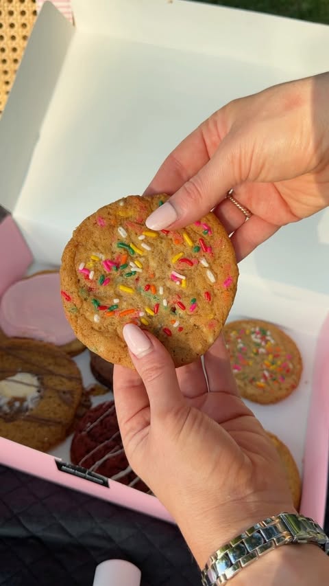 Instagram post by @lauramahachek for Crumbl Cookies. Caption reads: Summer evenings and a sweet treat after dinner....