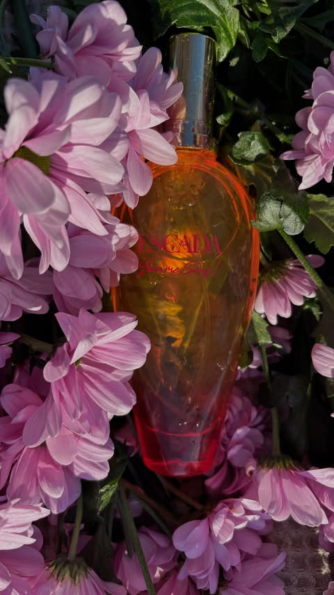 Instagram post by @alinaa.michele for Escada Fragrances. Caption reads: [...] 🍓✨ Wearing Yum Me Sunny! by....