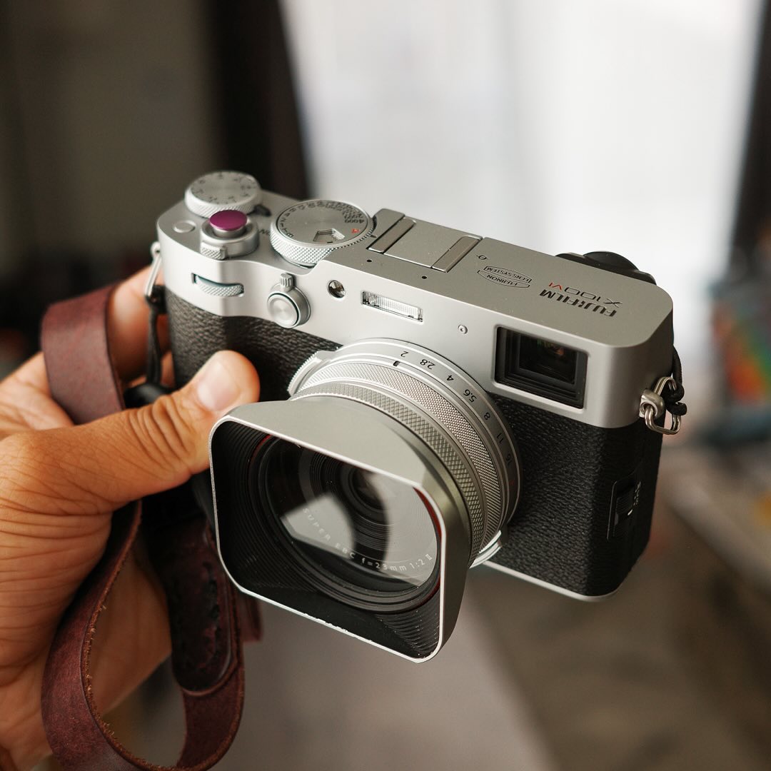 Instagram post by @reggiebphoto for Moment. Caption reads: [...] did I end up with the X100VI? Well as a....