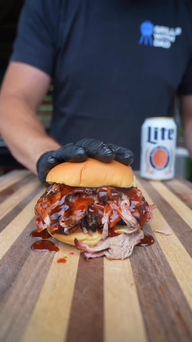Instagram post by @grillin_with_dad for Weber Grills. Caption reads: Boozy pulled pork. Injected, smoked AND finished....